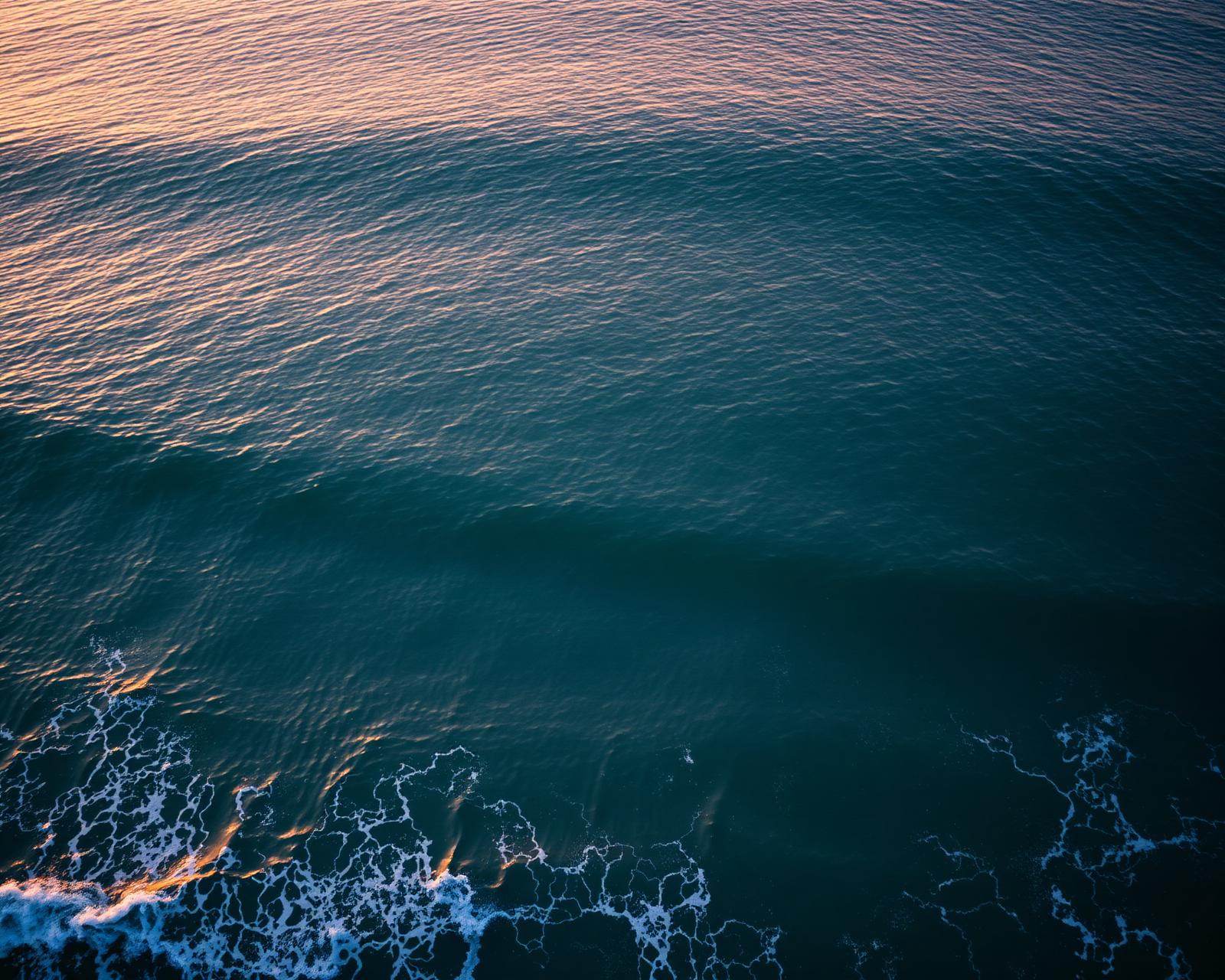 Aerial of ocean waves at dawn